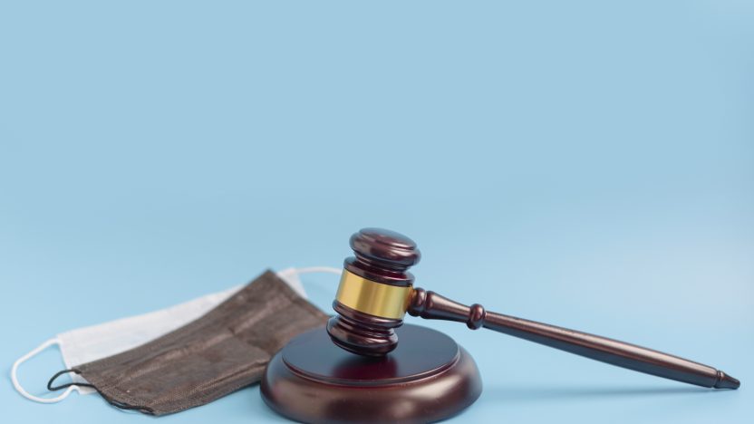 brown gavel medical protective masks blue background 832x468